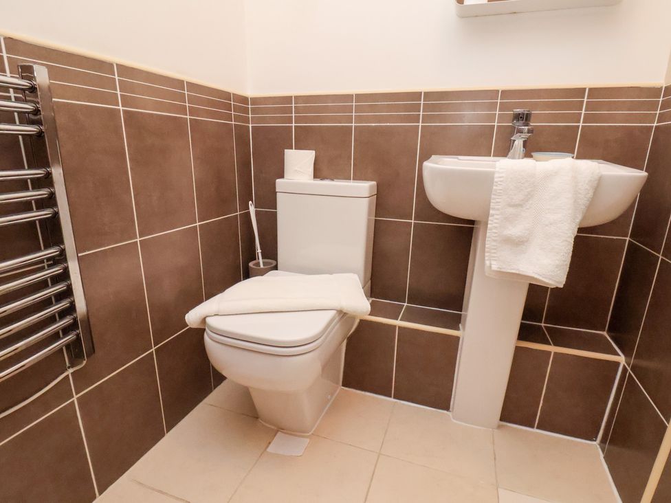 A bathroom with a toilet and sink at One Union Mill - garden apartment in Whitby