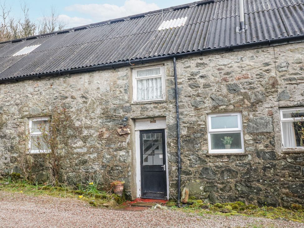 Exterior view of a stone cottage with a door and windows at Sycamore near Killean Farmhouse Cottages near Inveraray