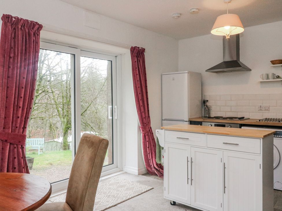 A kitchen with a refrigerator and stove at Sycamore near Killean Farmhouse Cottages near Inveraray