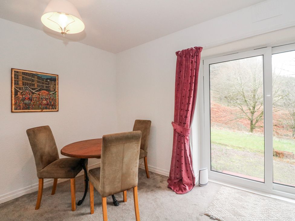 A dining room with a table and chairs at Sycamore near Killean Farmhouse Cottages Inveraray