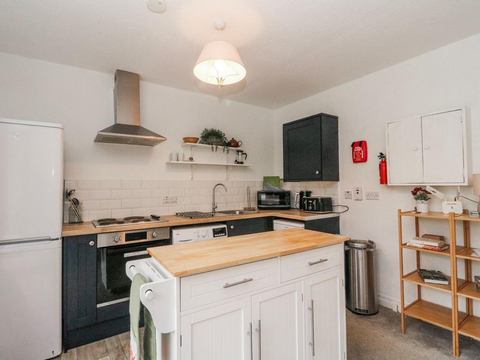 A kitchen with appliances and cabinets at Sycamore near Killean Farmhouse Cottages Inveraray