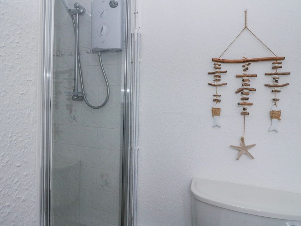 A bathroom with shower and toilet at Sycamore near Killean Farmhouse Cottages