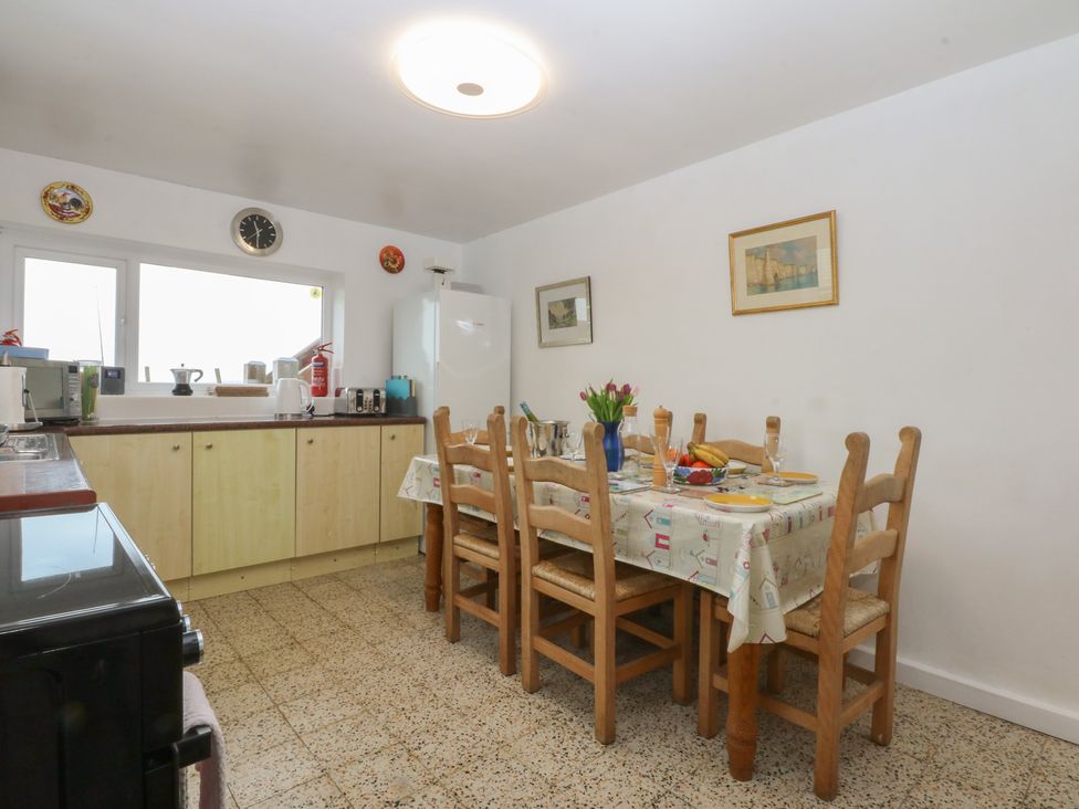 A kitchen with a dining table and chairs at Parc y Brenin Holidays, Abersoch