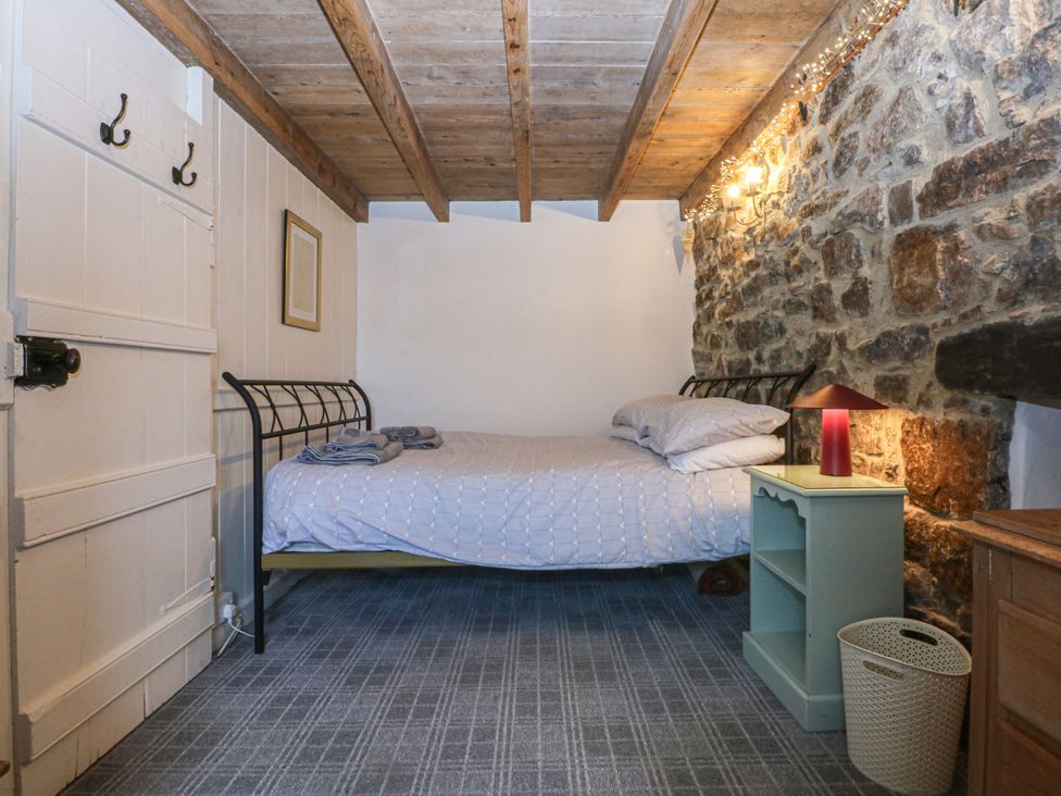 A bedroom with a bed and a nightstand at Parc y Brenin Holidays, Abersoch