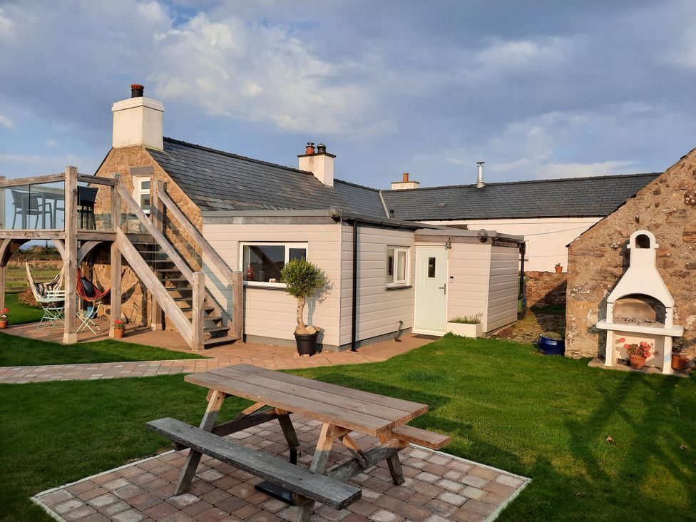 An outdoor area with a house, stairs, and seating at Parc y Brenin Holidays, Abersoch