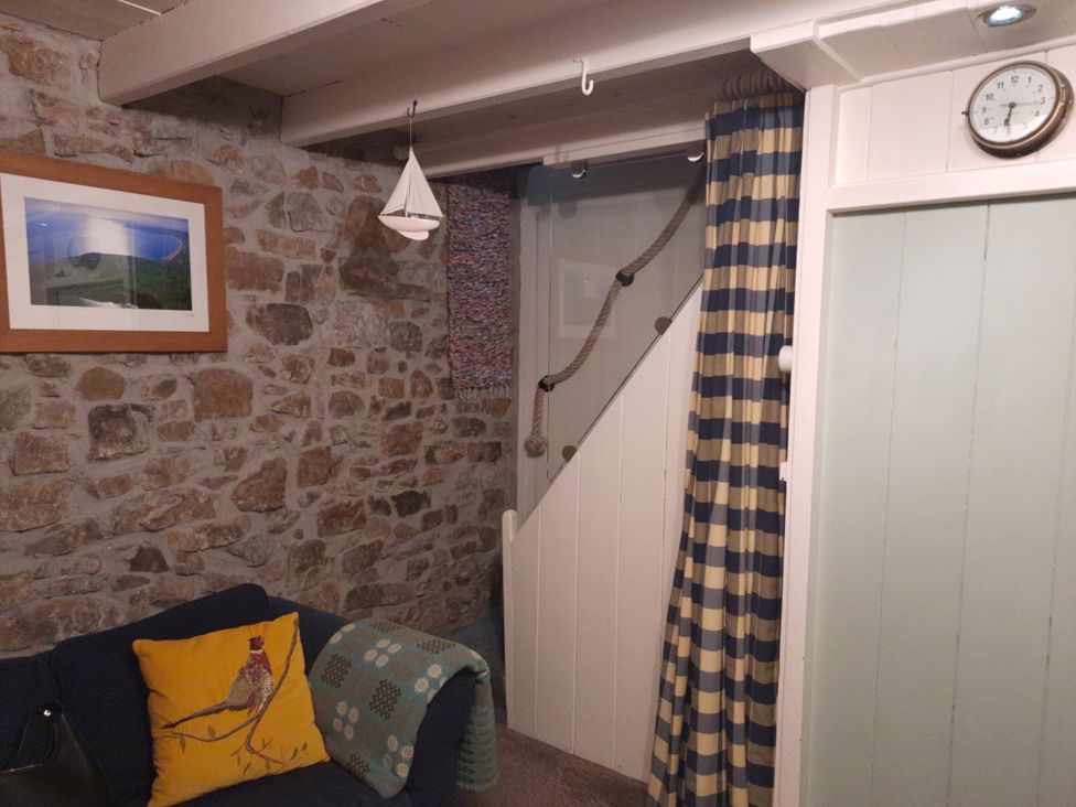 A living room with a sofa and photo frame at Parc y Brenin Holidays, Abersoch