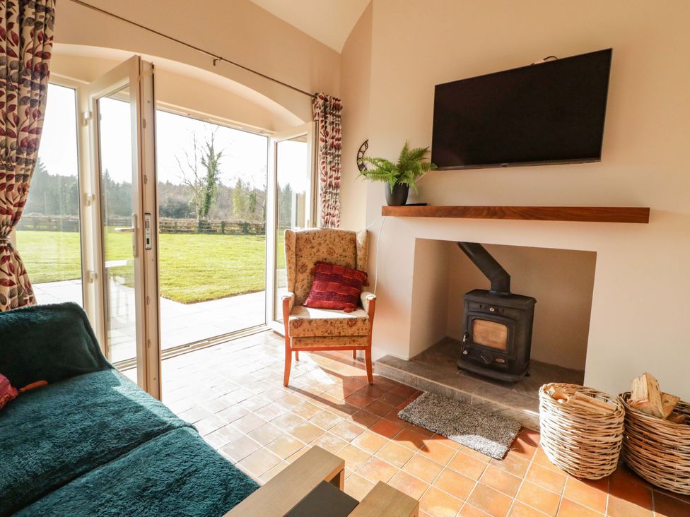 A living room with a sofa and a chair at Innishore Cottage