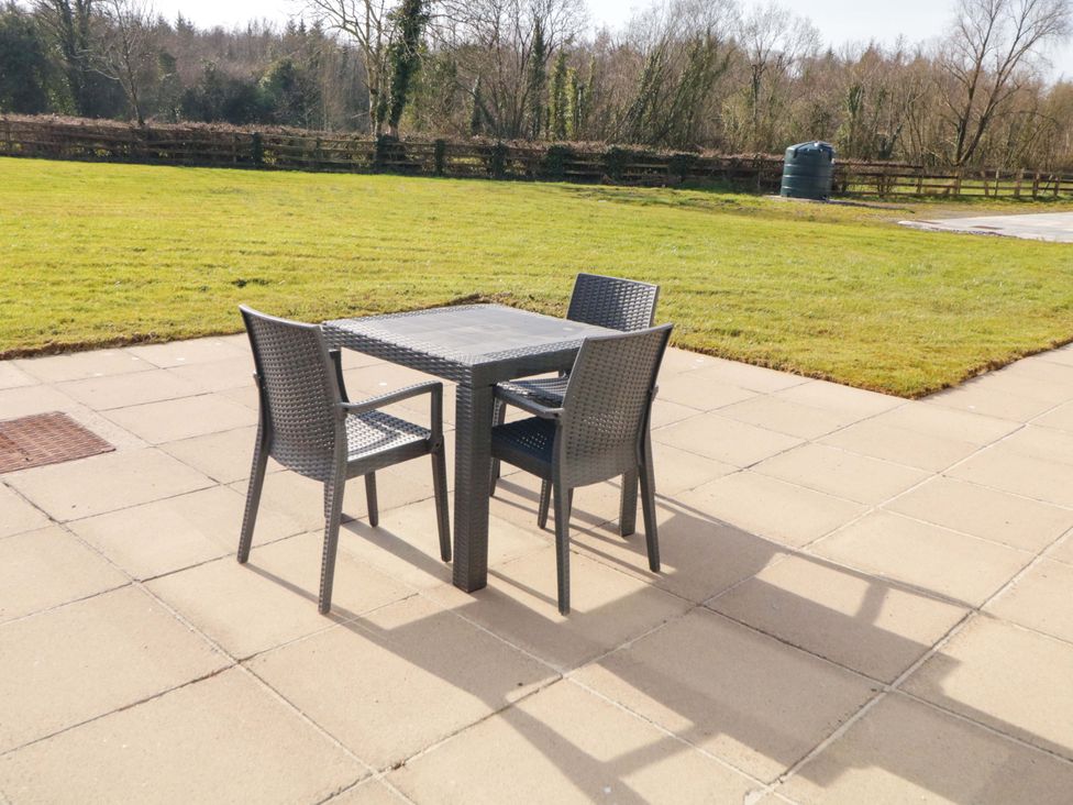 A table and chairs in an outdoor space at Innishore Cottage