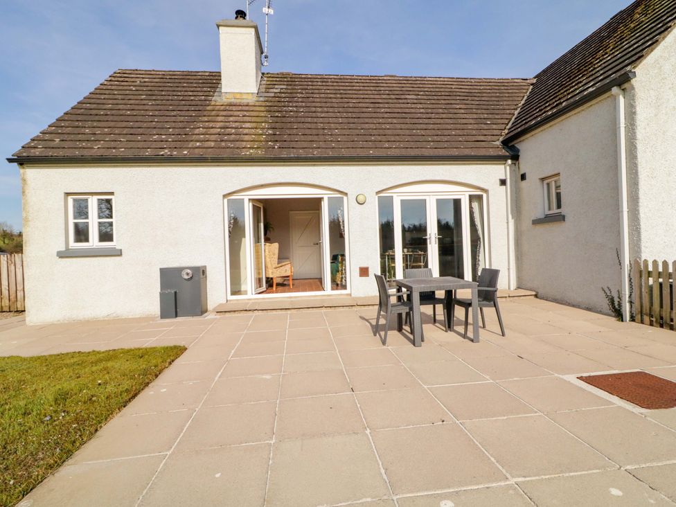 An outdoor patio with a table and chairs at Innishore Cottage 