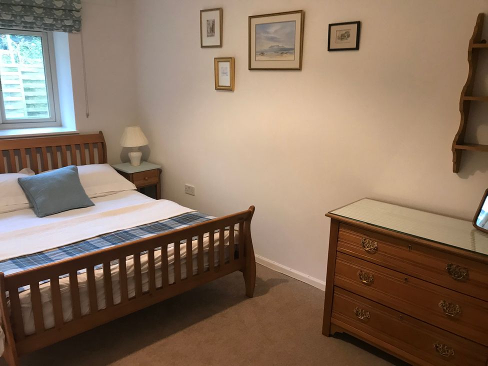 A bedroom with a bed and lamp at Meadow Lodge Cerney Wick near South Cerney, Cotswolds