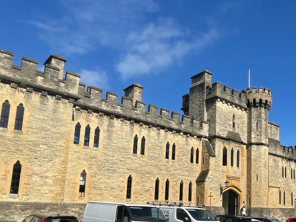 A castle building with towers and windows in the background at Meadow Lodge, Cerney Wick near South Cerney, Cotswolds
