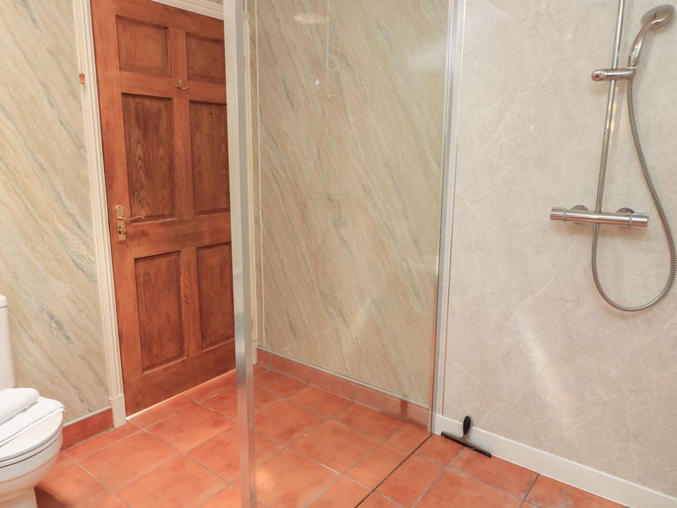 A bathroom with a shower and toilet at Meadow Lodge Cerney Wick near South Cerney, Cotswolds