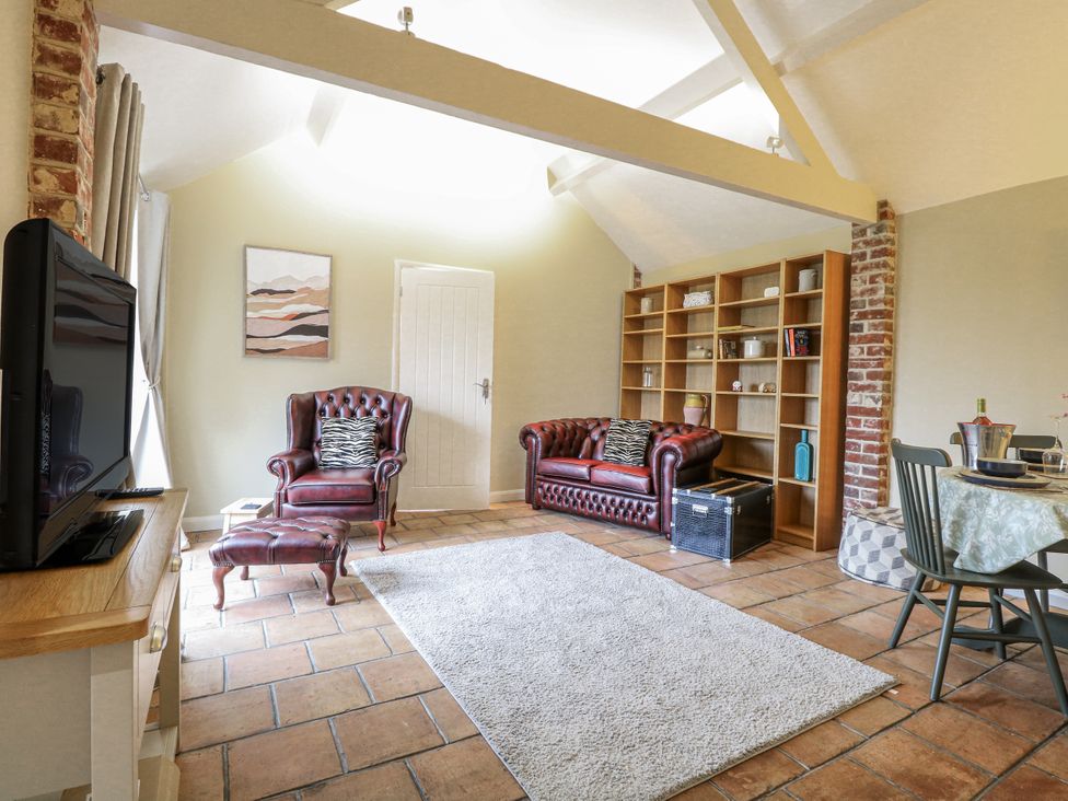 A living room with a television and sofas at Ivy Barn in Norwich