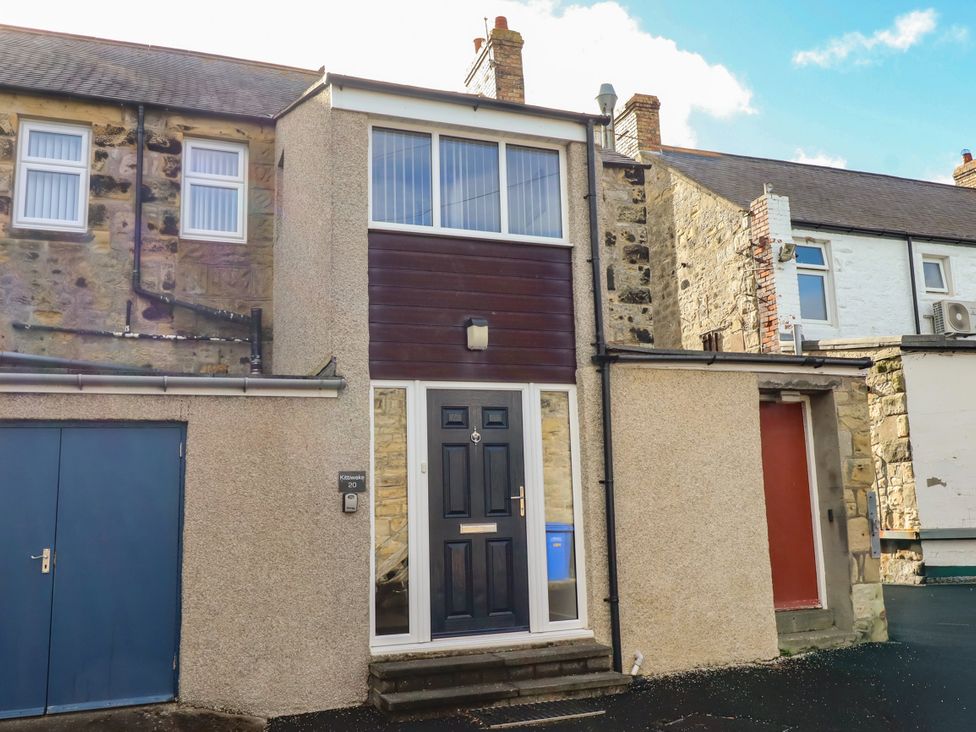 An exterior view of a house with a doorway and windows at Kittiwake at No 20 Seahouses
