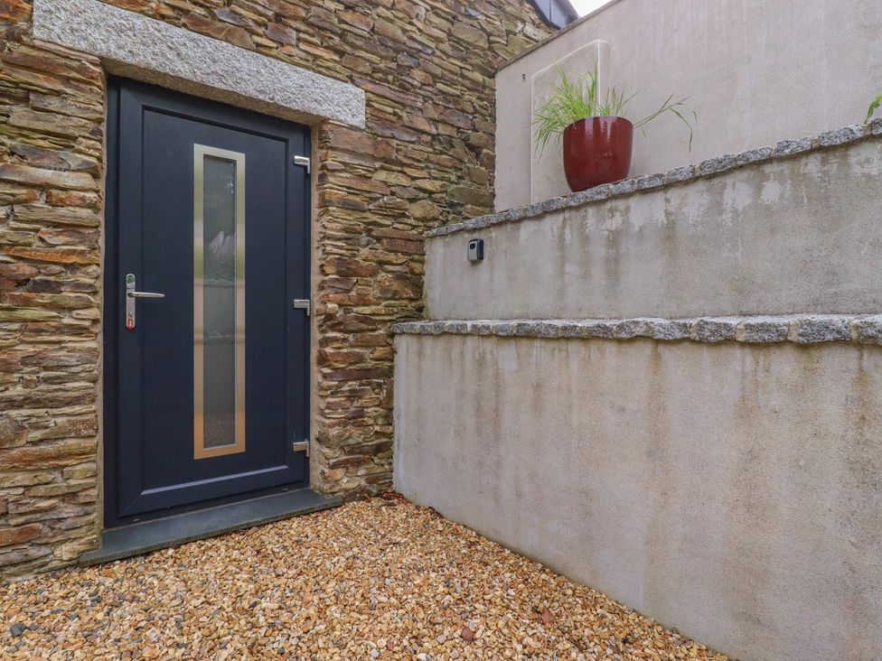 An entrance with a door and stone wall at The Annex At The Barn Pelynt