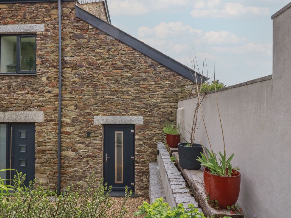An exterior view of a stone wall and planters at The Annex At The Barn in Pelynt