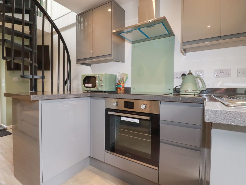 A kitchen with a kettle and microwave at The Annex At The Barn Pelynt