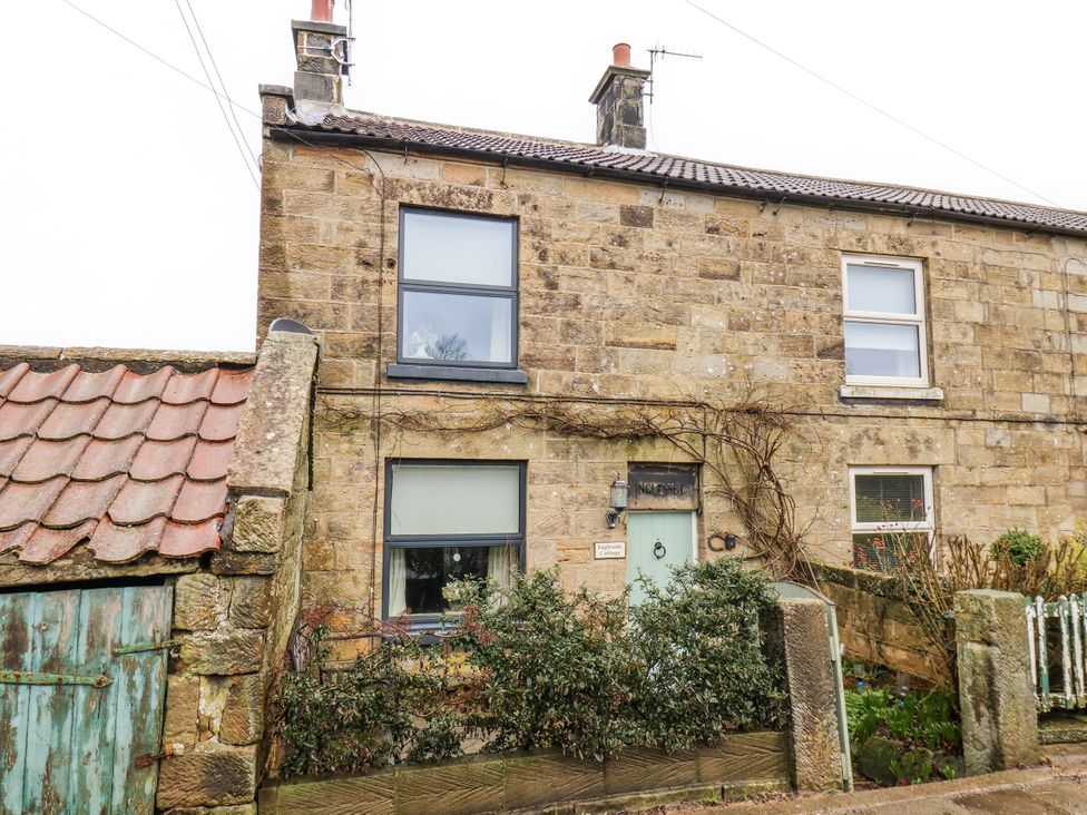 A stone house with windows and a door at Ingleside Cottage in Whitby