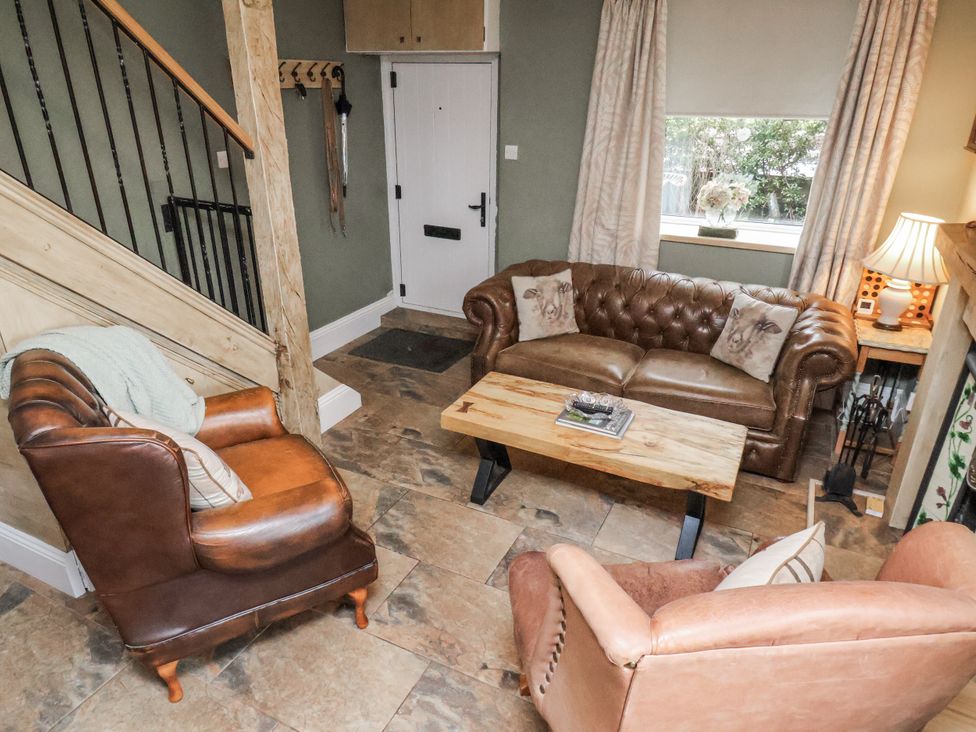 A living room with sofas and a coffee table at Ingleside Cottage in Whitby