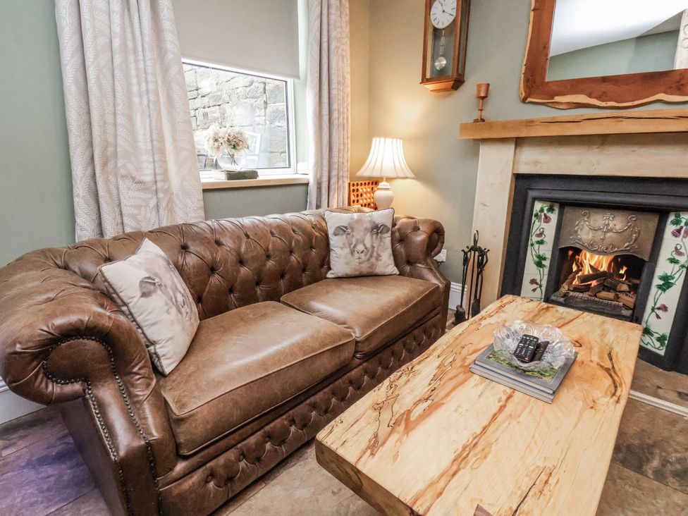 A living room with a sofa and coffee table at Ingleside Cottage in Whitby
