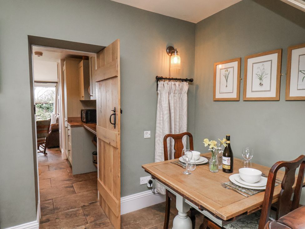 A dining area with a table and chairs at Ingleside Cottage in Whitby