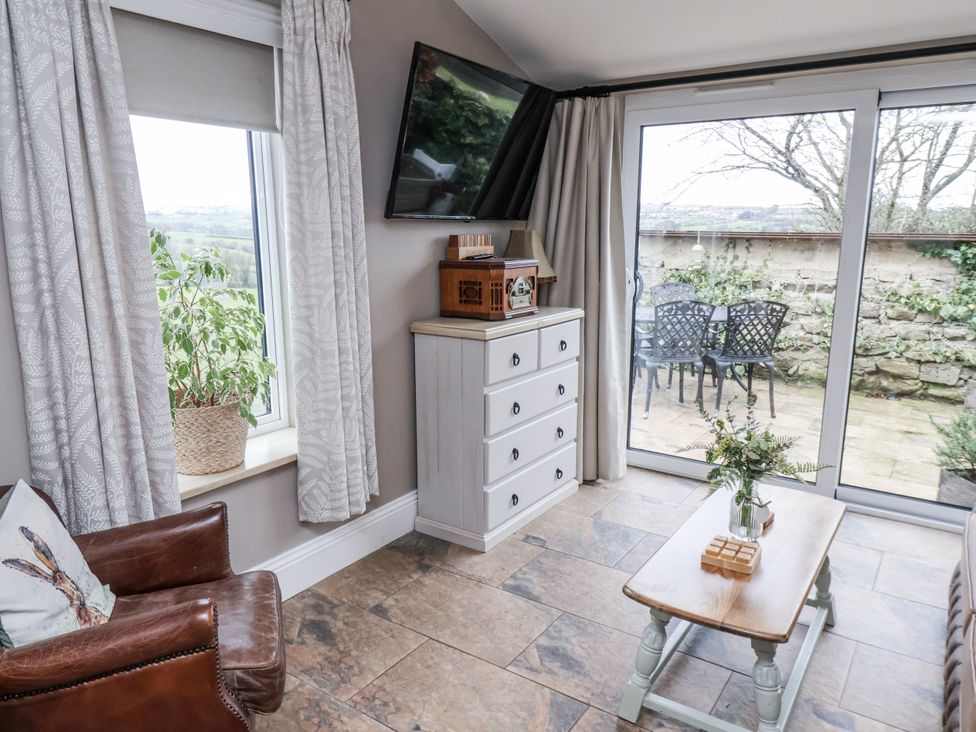 A living room with a plant and a coffee table at Ingleside Cottage in Whitby