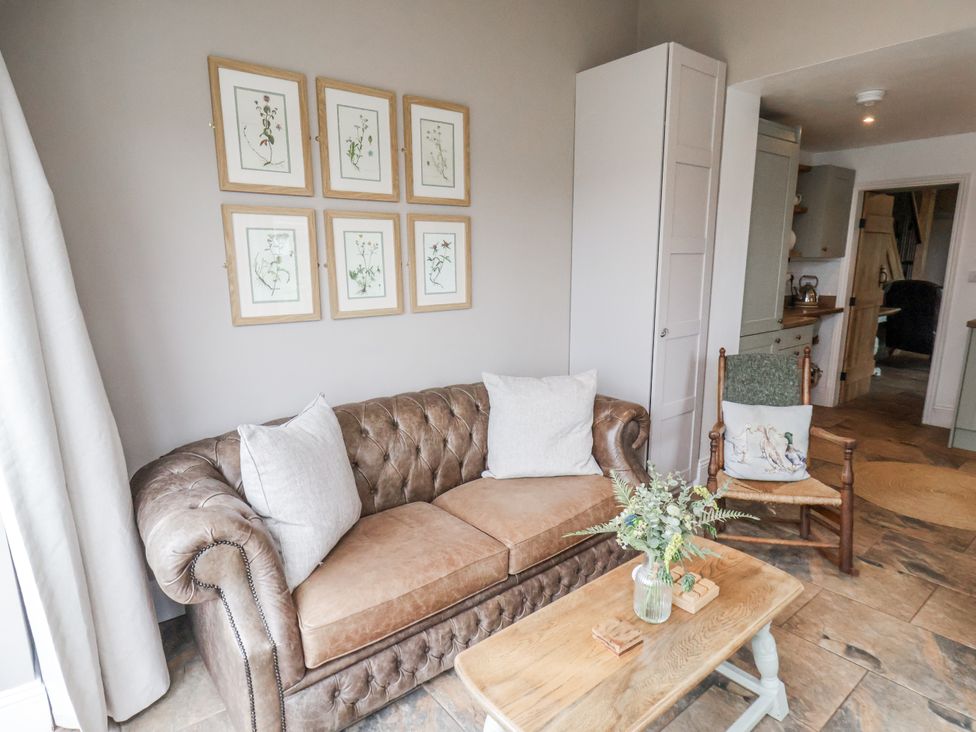 A living room with a sofa and coffee table at Ingleside Cottage in Whitby
