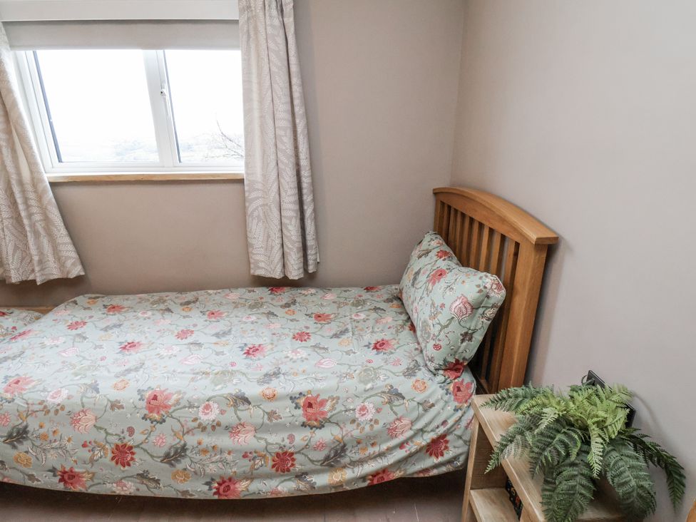 A bedroom with a bed and a window at Ingleside Cottage in Whitby