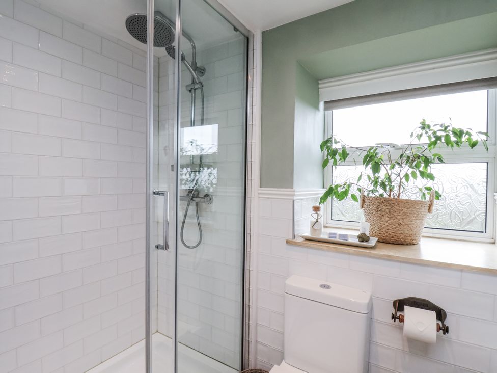 A bathroom with a shower and a toilet at Ingleside Cottage in Whitby