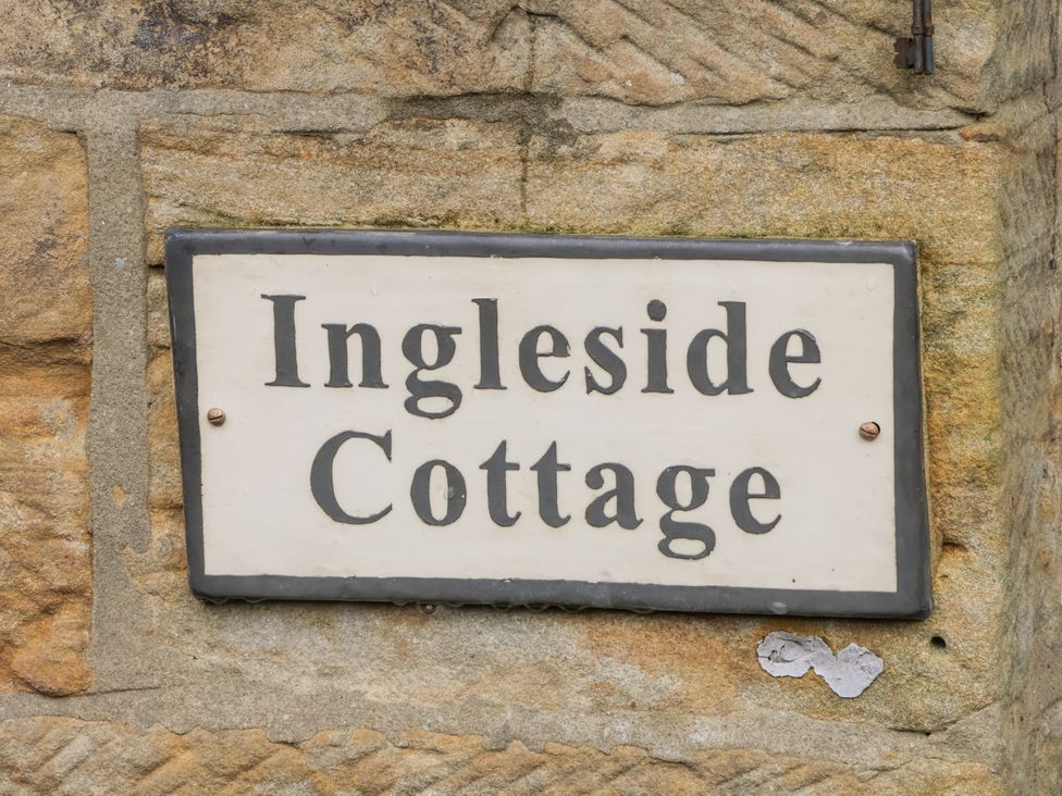 A cottage nameplate on a stone wall at Ingleside Cottage Whitby
