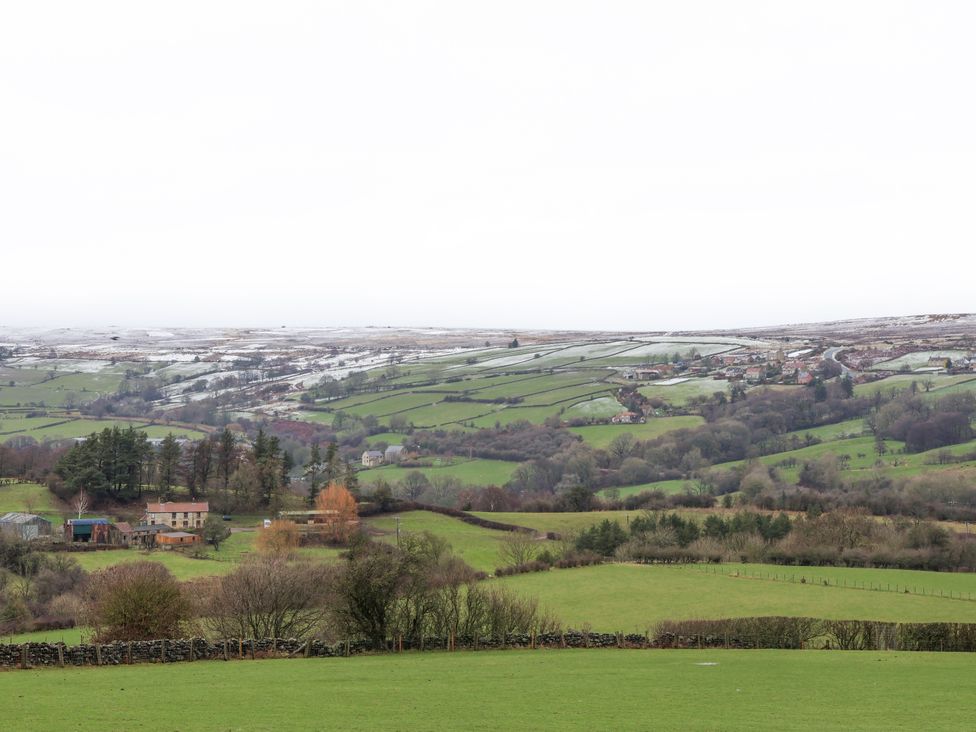 A landscape view with fields and houses at Ingleside Cottage in Whitby
