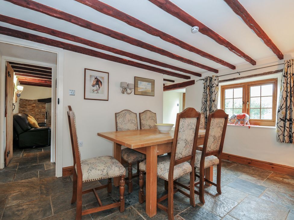 A dining room with a table and chairs at Little Blagdon in Beaworthy