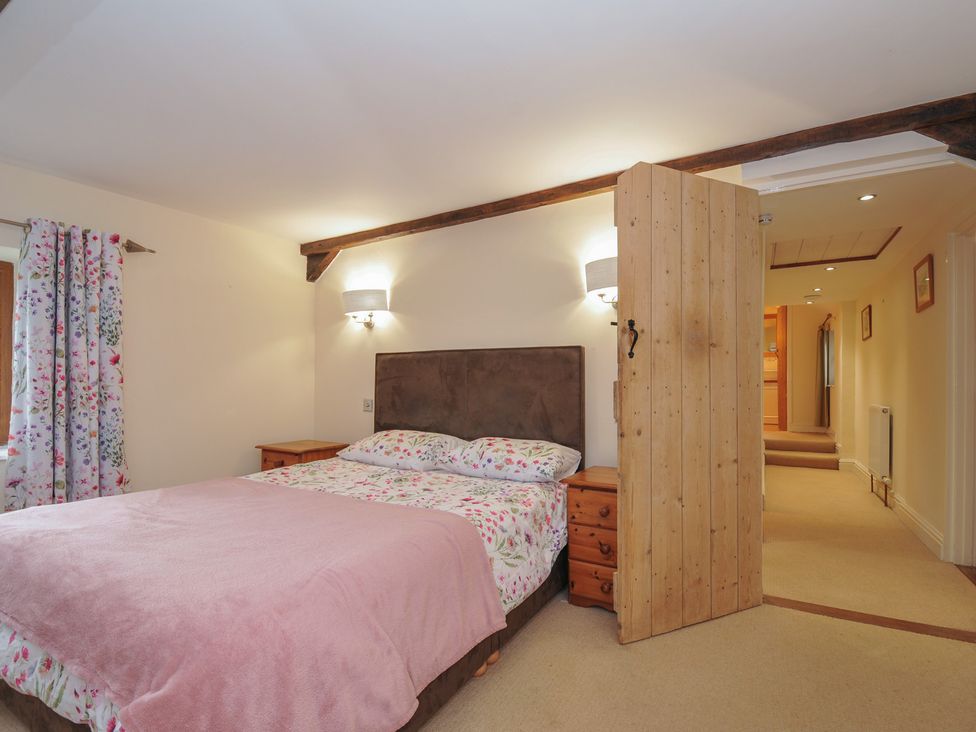 A bedroom with a bed and nightstand at Little Blagdon in Beaworthy