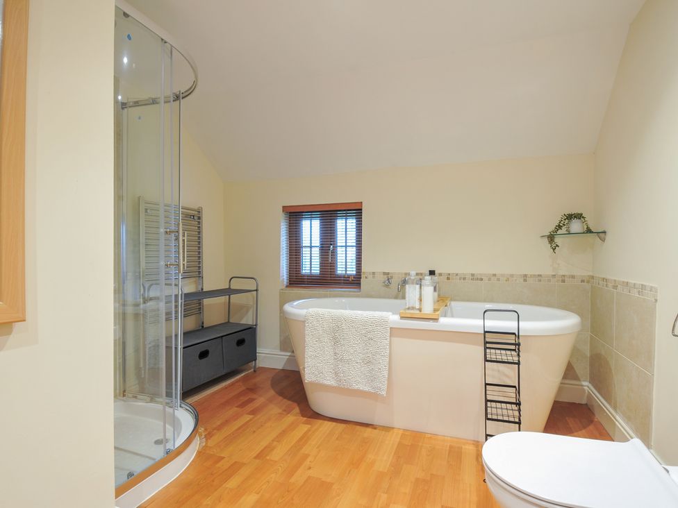 A bathroom with a bathtub and shower at Little Blagdon Beaworthy