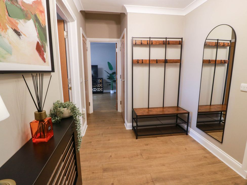 A hallway with a coat rack and a mirror at Flat 1 86 Gallowgate Street Largs