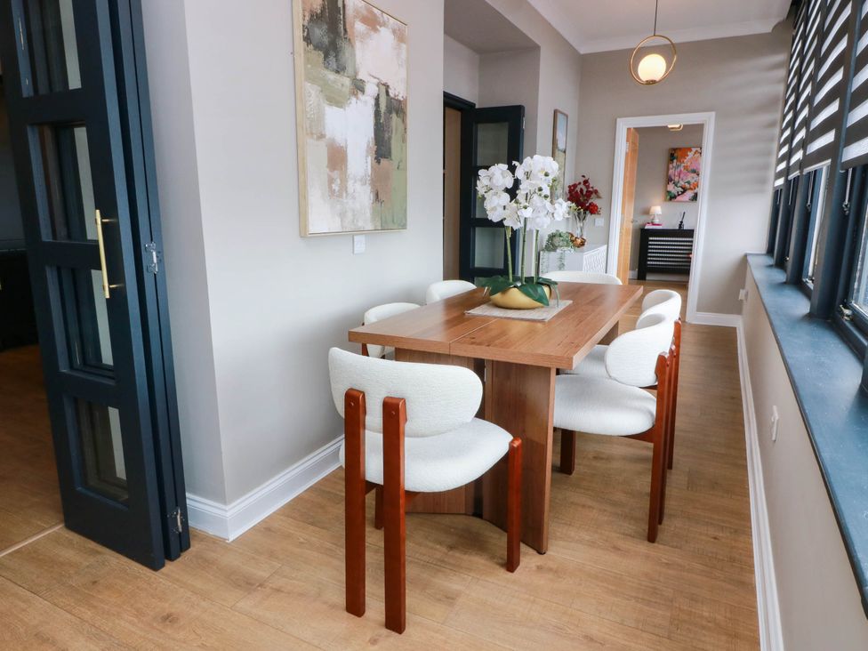A dining room with a table and chairs at Flat 1 86 Gallowgate Street Largs