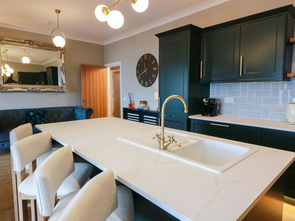 A kitchen with a sink and island at Flat 1 86 Gallowgate Street Largs