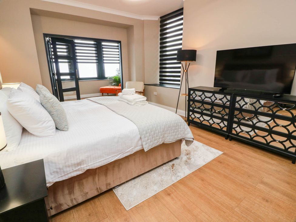 A bedroom with a bed and television at Flat 1 86 Gallowgate Street Largs