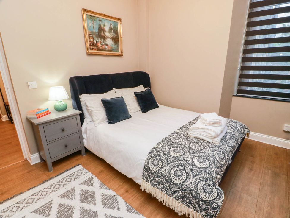A bedroom with a bed and bedside table at Flat 1 86 Gallowgate Street Largs