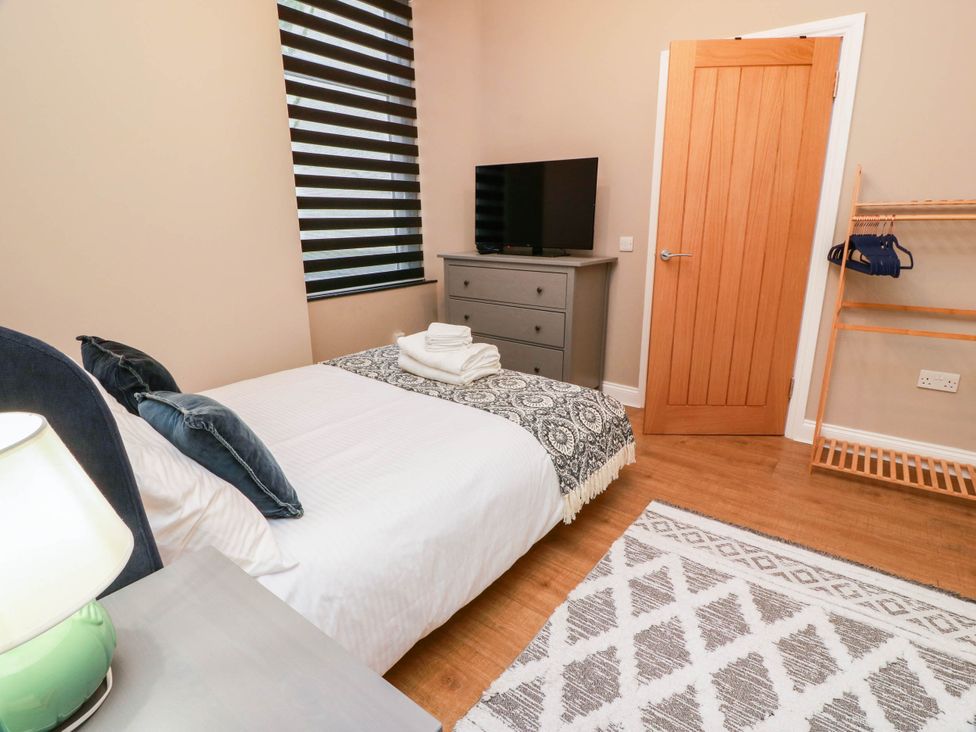 A bedroom with a bed and television at Flat 1 86 Gallowgate Street Largs