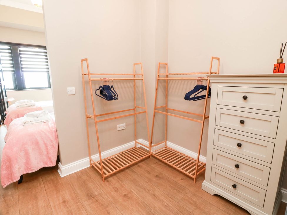 A bedroom with clothes racks and a dresser at Flat 1 86 Gallowgate Street in Largs