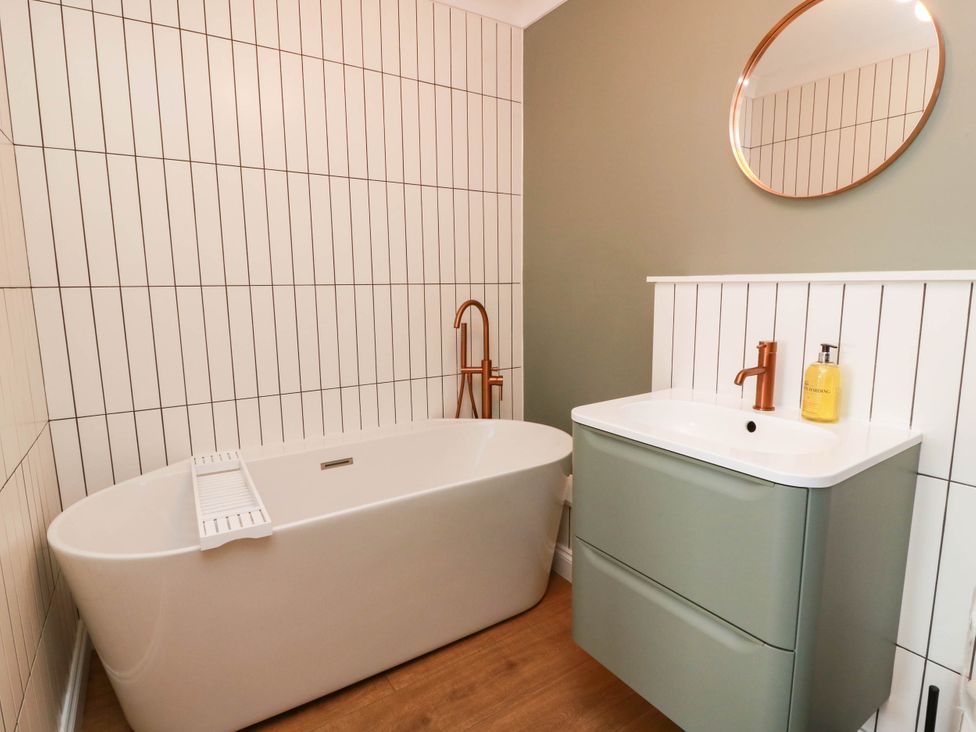 A bathroom with a bathtub and vanity unit at Flat 1 86 Gallowgate Street in Largs