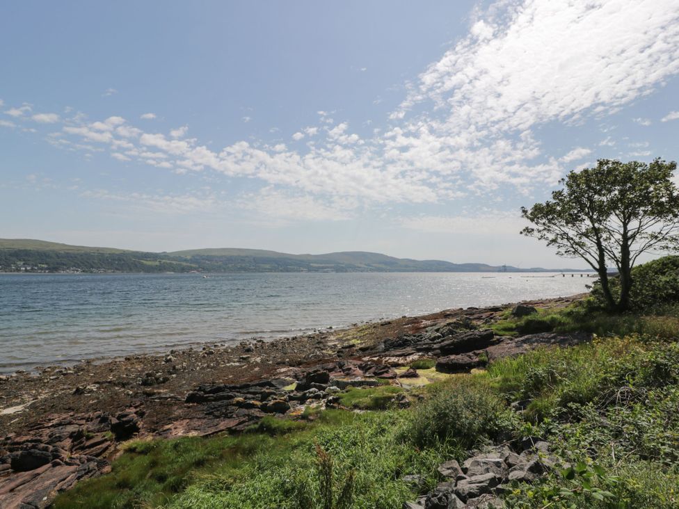 A coastal view with water rocks and a tree at Flat 1 86 Gallowgate Street Largs
