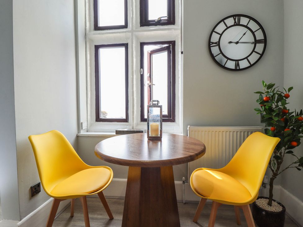 A dining room with a table and two chairs at The Ocean House   --- Sea Whisper (Top Floor )  Le Strange Terrace in Hunstanton