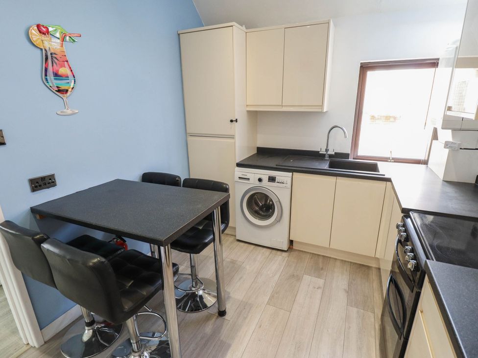 A kitchen with a table and chairs at The Ocean House   --- Sea Whisper (Top Floor )  Le Strange Terrace, Hunstanton