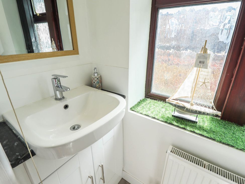 A bathroom with a sink and mirror at The Ocean House   --- Sea Whisper (Top Floor )  Le Strange Terrace, Hunstanton