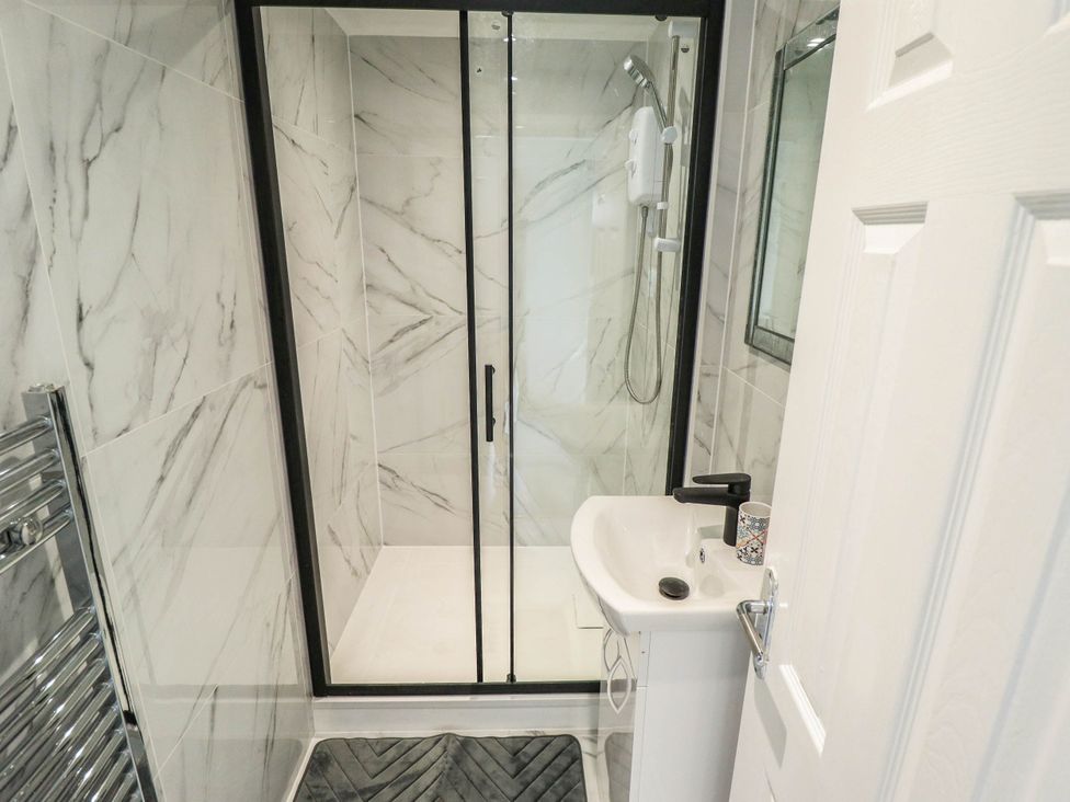 A shower and sink in a bathroom at The Ocean House   --- Sea Whisper (Top Floor )  Le Strange Terrace, Hunstanton