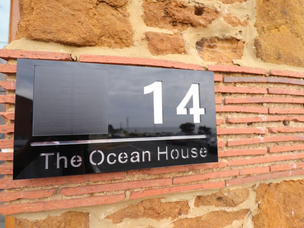 A house sign displaying number 14 and the name The Ocean House