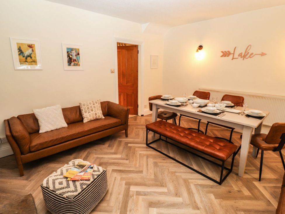 A dining room with a table set for a meal at Waterhead Cottage in Ambleside