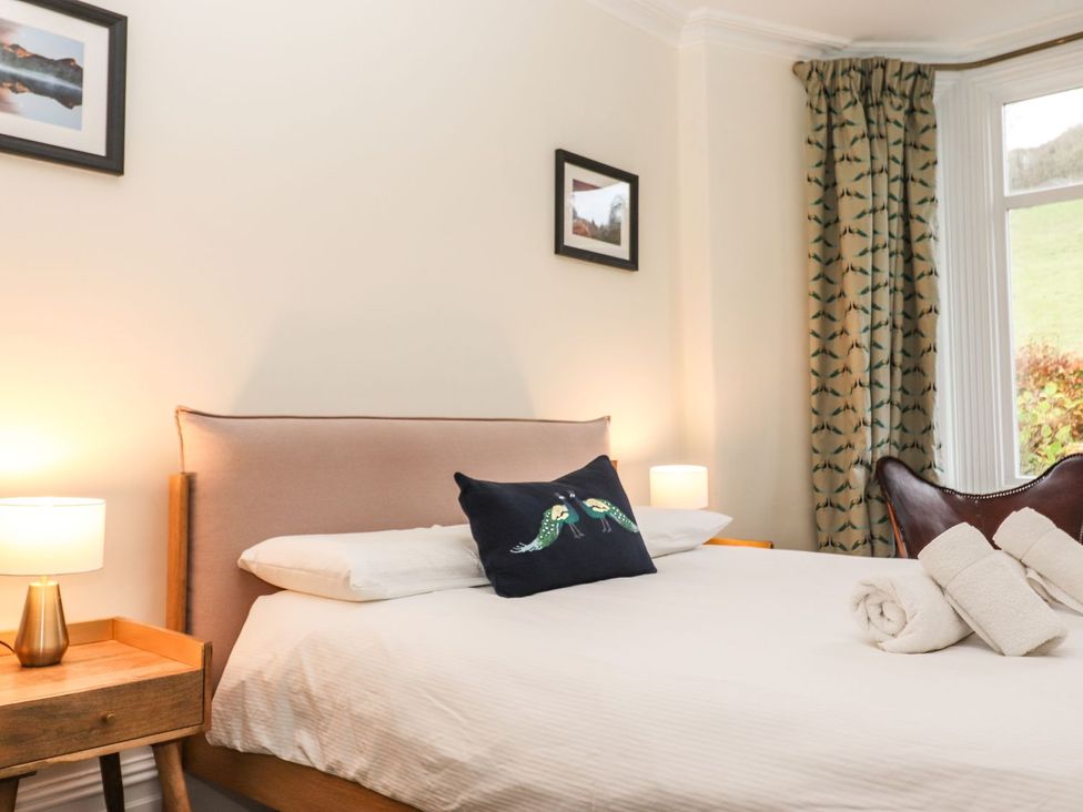 A bedroom with a bed and bedside table at Waterhead Cottage in Ambleside